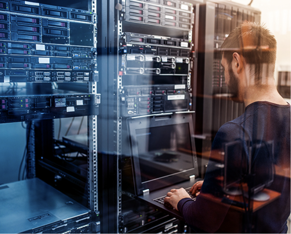Network engineer working in server room configuring network equipment